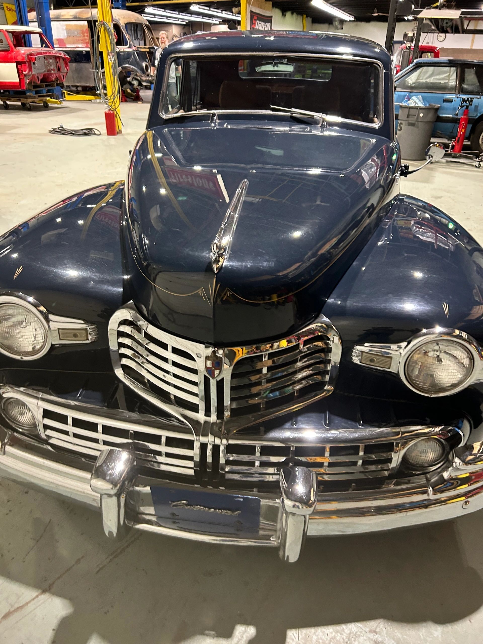 Vintage black classic car under restoration inside the 2240 Speed Shop garage in Edmonton