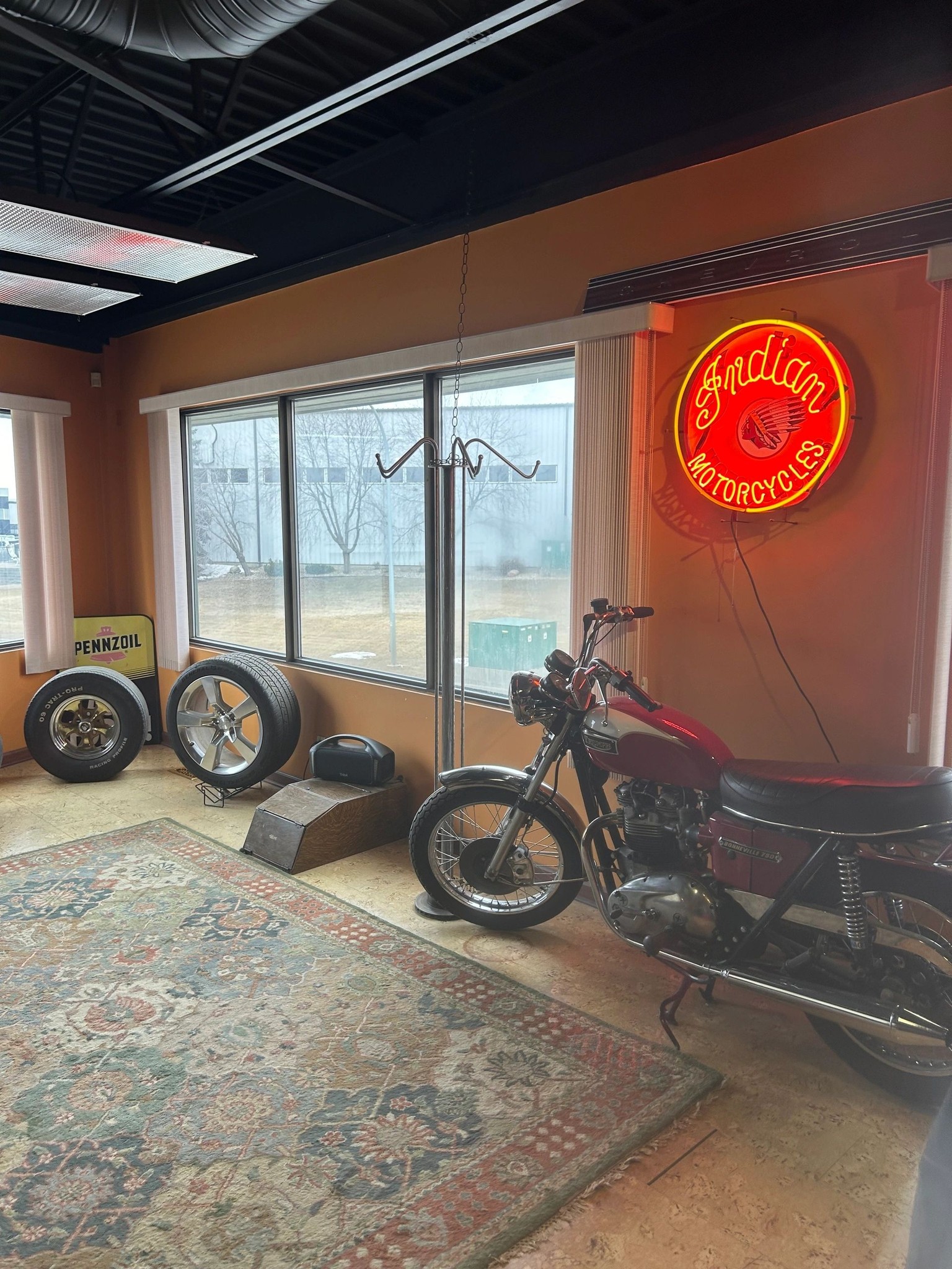 Neon signs and classic machines inside the 2240 Speed Shop showroom in Edmonton at night